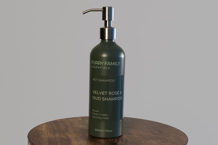 Furry Family Essentials pet shampoo bottle on a wooden surface with a gray background